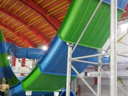 Multi-lane water slides with colorful flumes and a supporting steel tower