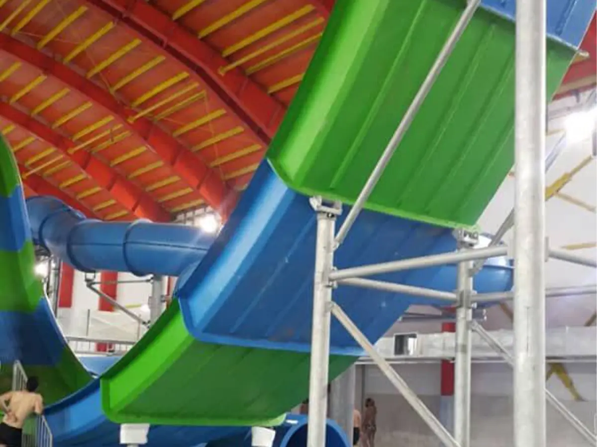 Multi-lane water slides with colorful flumes and a supporting steel tower