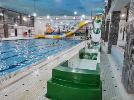 Water slide installation beside an outdoor swimming pool